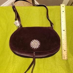 Dark purple handbag with crystal ornament.